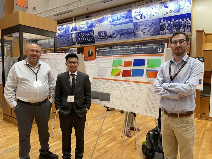 Lab members with posters at the MAE graduate research symposium